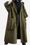 A person is sporting an *Army Green One Size Fits All Oversized Waterproof Windbreaker Jacket* by *looselyboho*. The jacket, featuring a hood and large front pockets, is buttoned up and has wide sleeves that reach just below the elbows. The stylish look is completed with a black top and jeans against a plain white background.